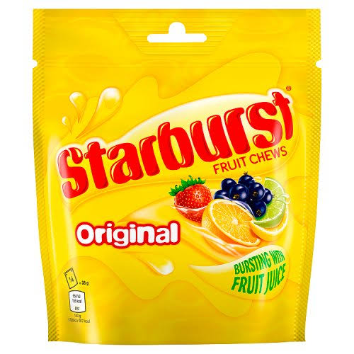 Bright yellow fruit chew candy packet with fruit illustrations on the front