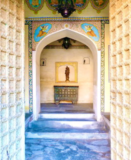 Ornate arched doorway with colorful decoration in a historic Indian interior