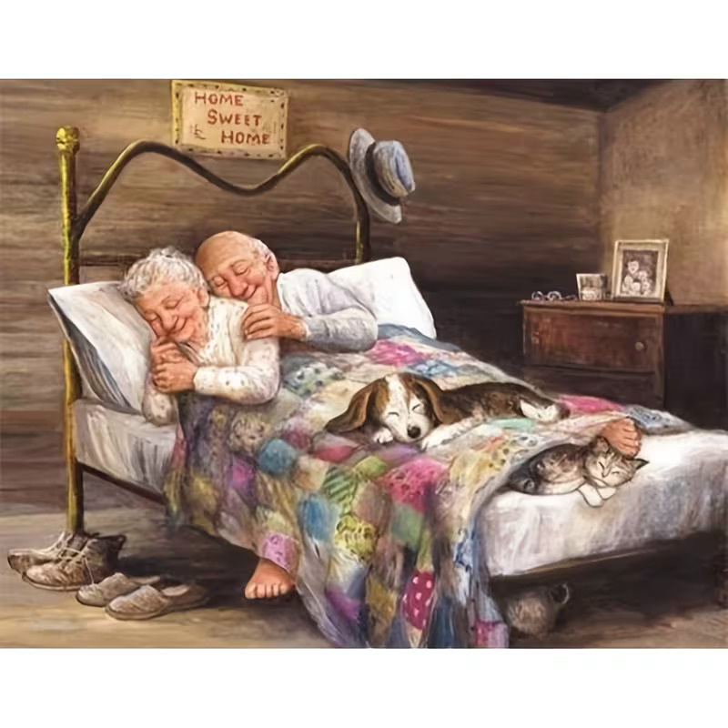 Elderly couple reading in bed with cats and colorful quilt in cozy wooden bedroom