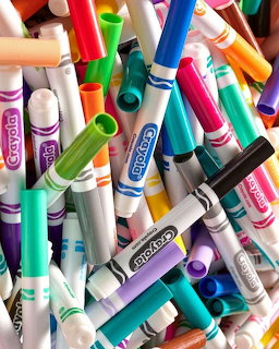 Close-up of a pile of colorful markers and pens scattered together