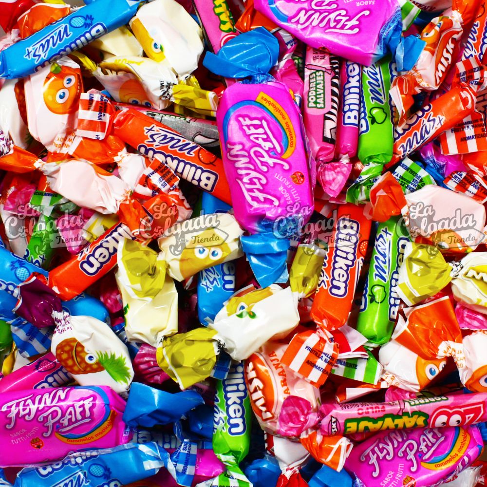 Pile of assorted wrapped candies in colorful packaging including pink, blue, red, yellow, and green wrappers