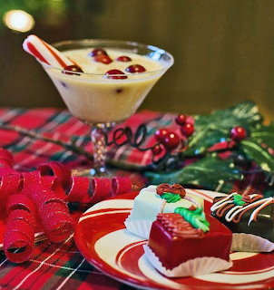 Two glasses of eggnog with cinnamon sticks and nutmeg in a festive holiday setting