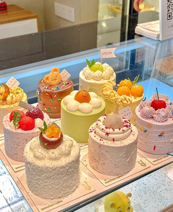 Colorful decorated mini cakes with frosting and toppings