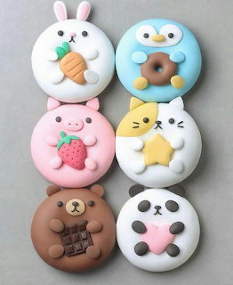 Six kawaii animal-shaped donuts arranged in a grid, decorated as buny, penguin, pig, cat, bear, and panda