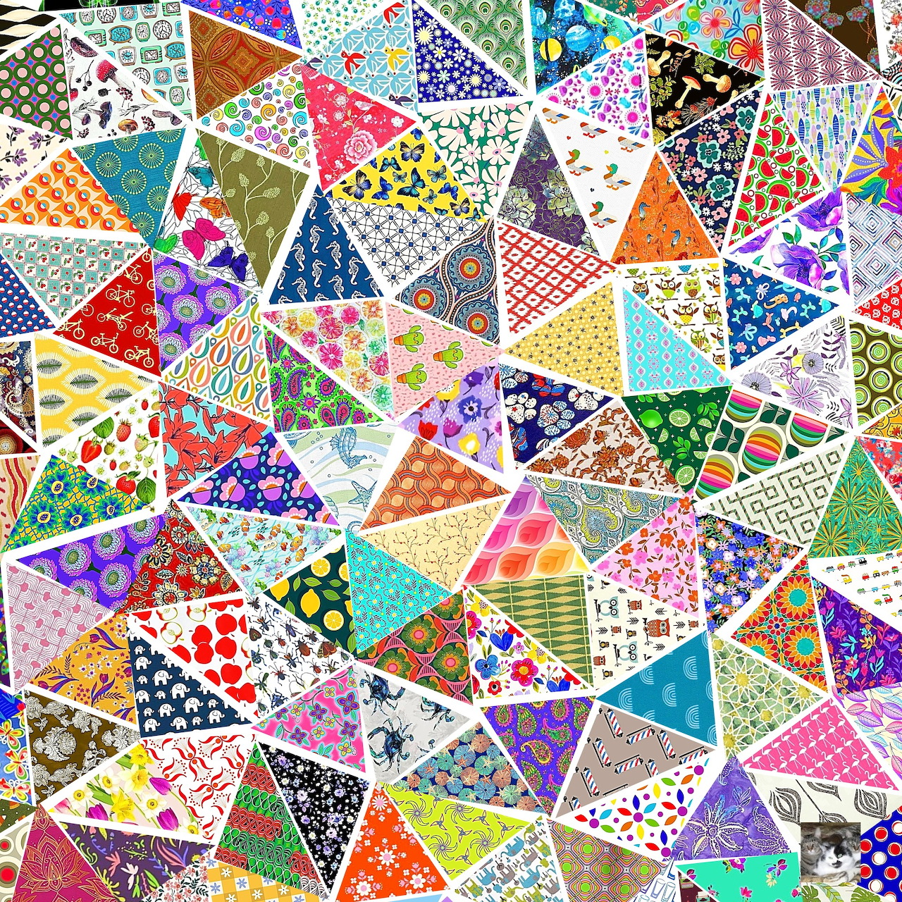 Colorful triangular patchwork quilt with diverse patterns including dots, stripes, flowers, and geometric shapes