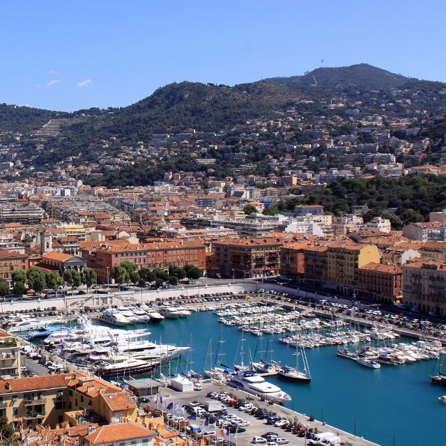 Aerial view of Mediterranean harbor with boats and hillside town