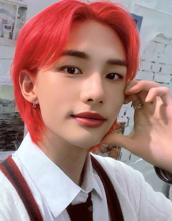 Young man with bright red hair and white shirt posing for a close-up selfie-style photo