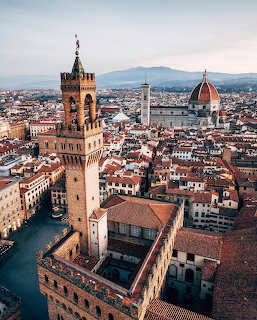 Aerial view of Florence with Palazzo Vecchio tower and Florence Cathedral dome at sunset