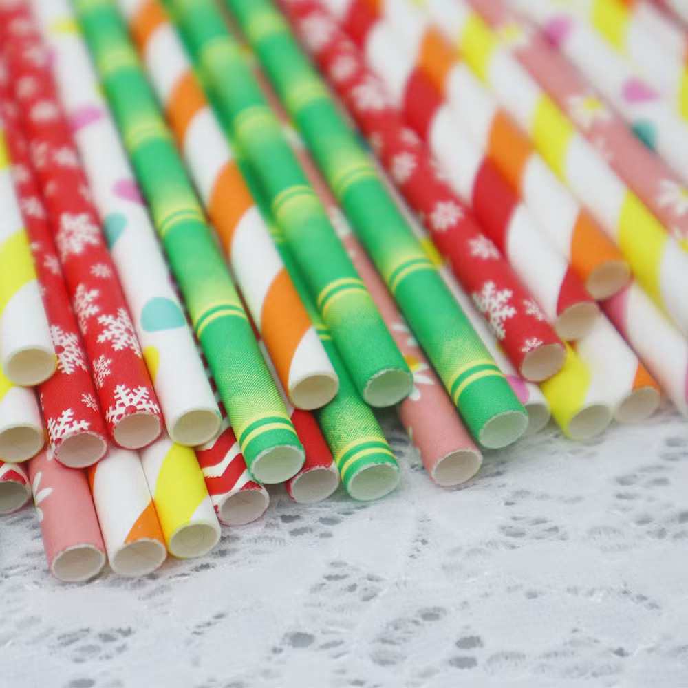 Assorted colorful paper straws with decorative patterns laid on white background