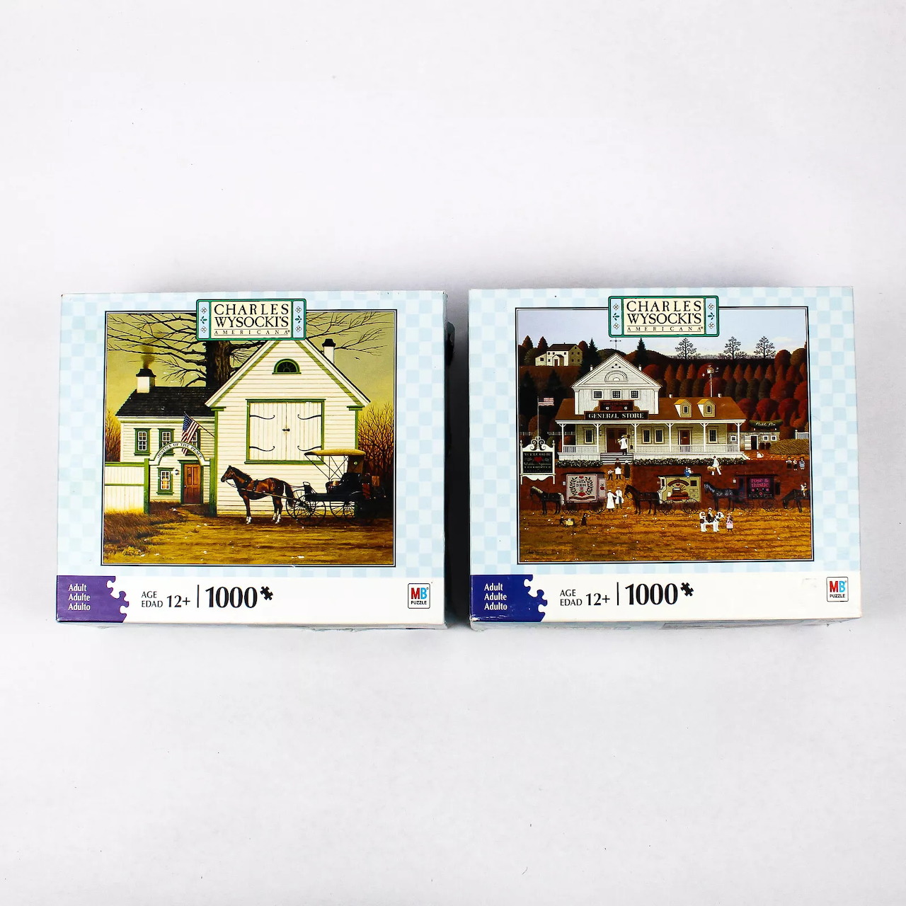 Two jigsaw puzzle boxes showing building illustrations, labeled 1000 pieces each