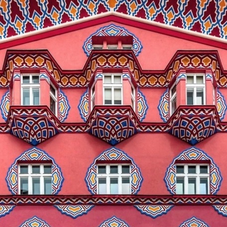 Pink and red ornamented facade of Vurnik House in Ljubljana