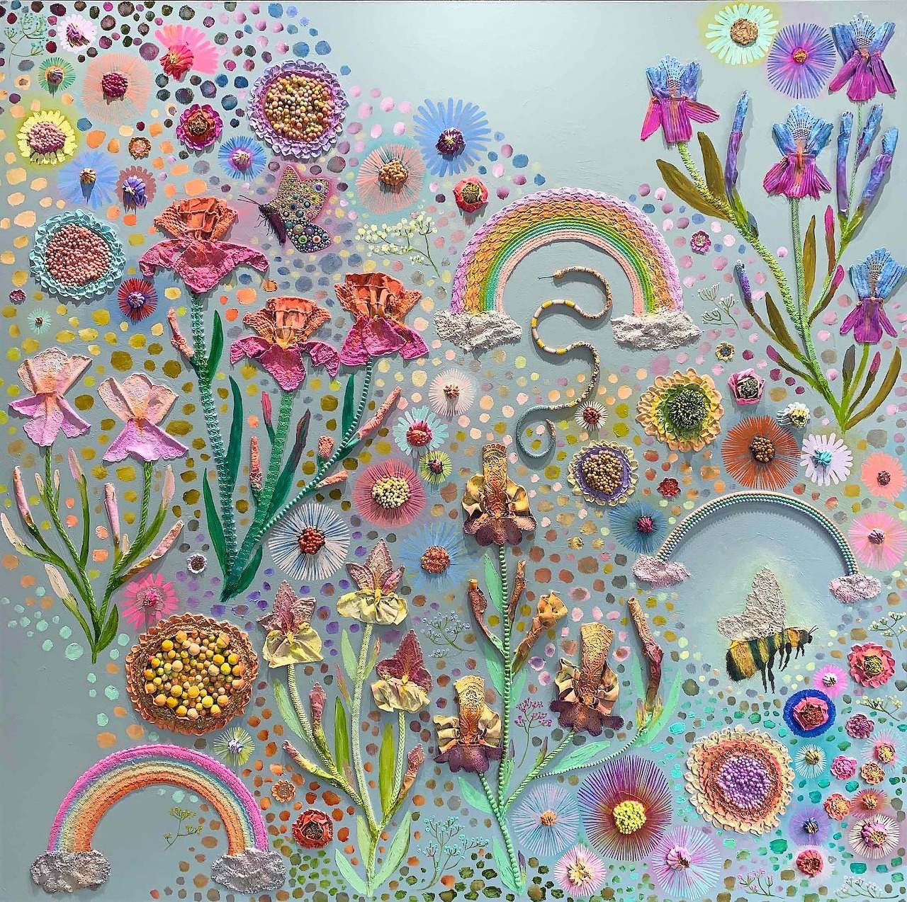 Mixed media art with beaded flowers, rainbows, and colorful embellishments on textured pastel background