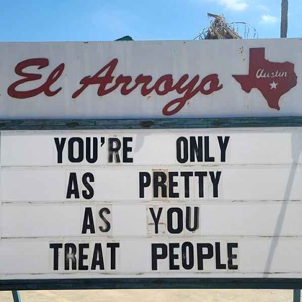 El Arroyo marquee sign in Austin, Texas with a message about treating people