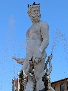 White marble Neptune statue with crown and trident at the Fountain of Neptune in Florence, Italy