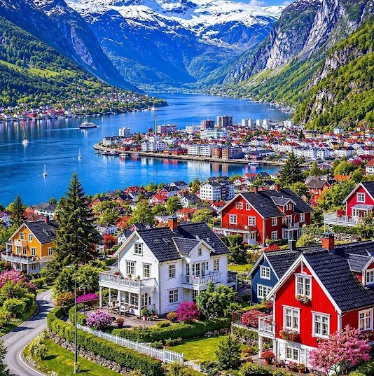 Colorful houses above the fjord in Odda, Norway, with mountains surrounding the town