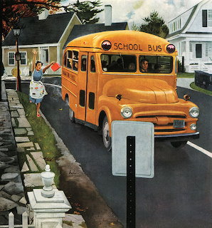 Orange school bus on suburban street with white picket fence and houses