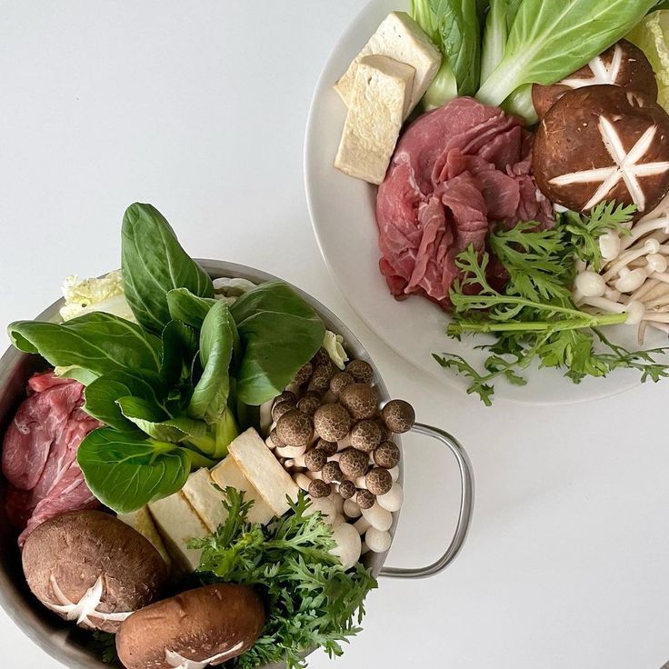 Two bowls with Korean hot pot ingredients including beef, tofu, mushrooms, and leafy greens