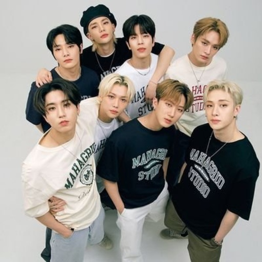 Seven young men posing together in casual shirts in a studio portrait