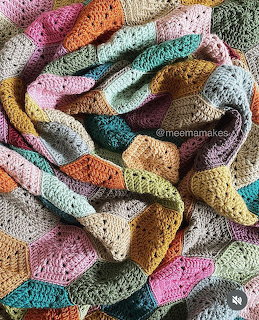 Colorful knitted granny square blanket with patchwork design in pastel and bright colors