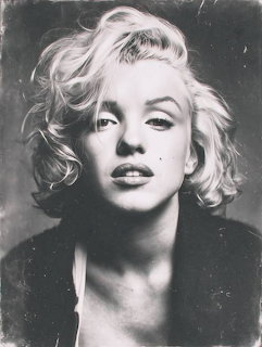 Black and white portrait of Marilyn Monroe with blonde wavy hair looking at camera