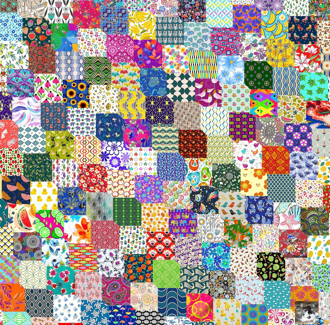 Colorful patchwork quilt with hundreds of small fabric squares in various patterns and colors arranged in a grid