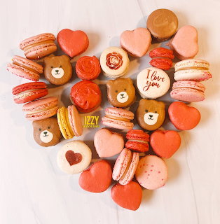 Heart-shaped collection of decorated macarons in valentine colors with bear and heart designs