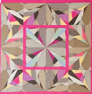 Colorful patchwork quilt with geometric star pattern in pink, beige, brown and yellow