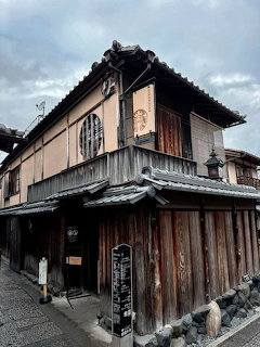 Traditional Japanese wooden machiya building with dark timber exterior and tiled roof in Kyoto