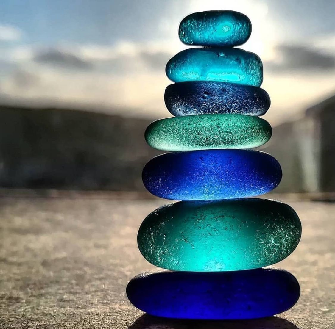 Glass Stones Stacked on Beach