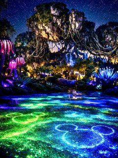 Bioluminescent glowing water and floating mountains at Pandora World of Avatar at night