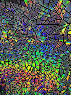Holographic mosaic pattern with rainbow-colored geometric fragments creating iridescent shimmering effect