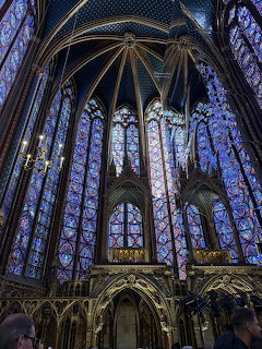 Interior view of Sainte Chapelle chapel showing tall blue stained glass windows and vaulted ceiling