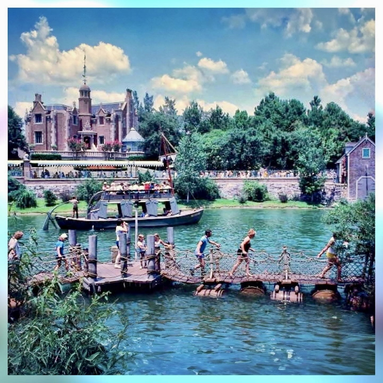 People on a floating raft crossing a river with a manor building and trees behind them