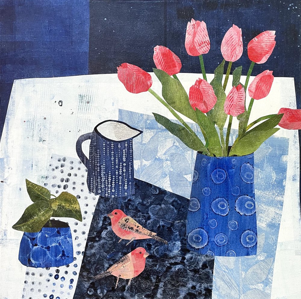 Still life painting of coral tulips in blue vase with pitcher on white table against dark blue background
