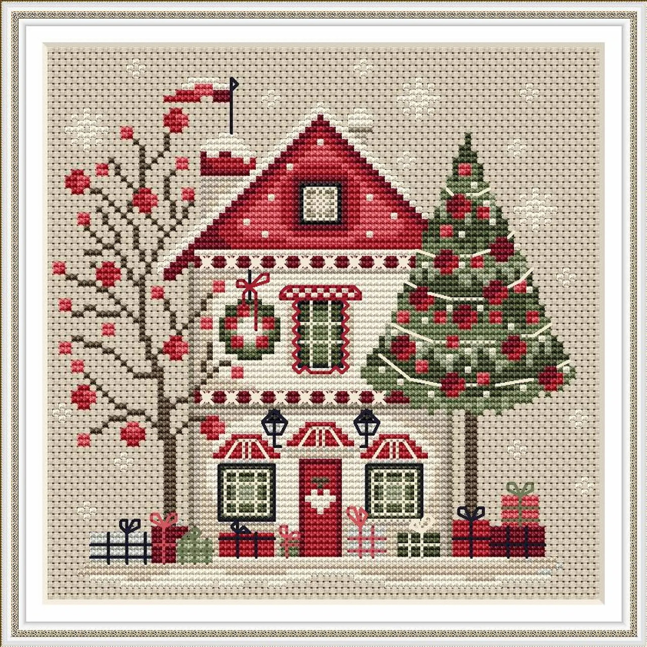 Cross-stitch needlework depicting a Christmas house with decorated tree and snowy branches