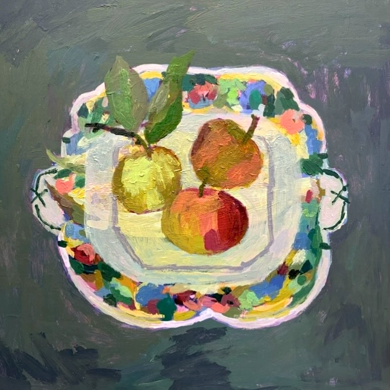 Still life painting of three apples on a floral decorated plate with leaves on dark teal background