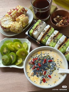 Korean meal with kimbap, fried chicken, soup, grapes and tea on wooden table