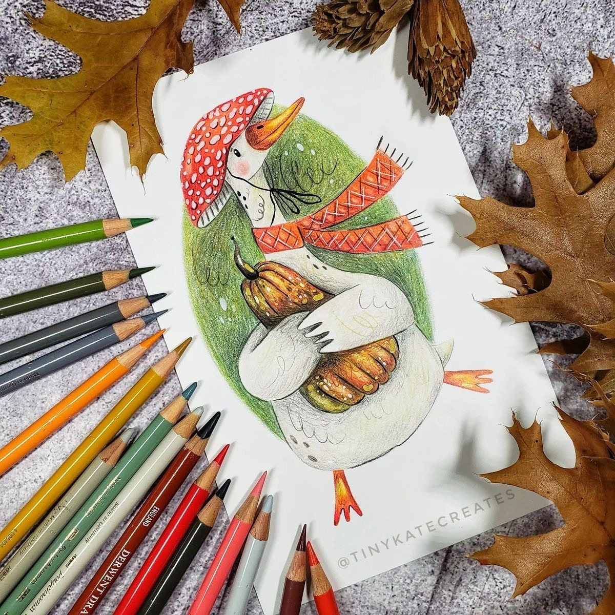 Bird illustration on paper with colored pencils and autumn leaves around it