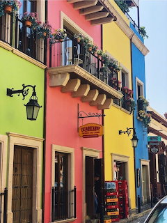 Colorful street with bright building facades, balconies, doors, and lanterns in Monterrey, Mexico
