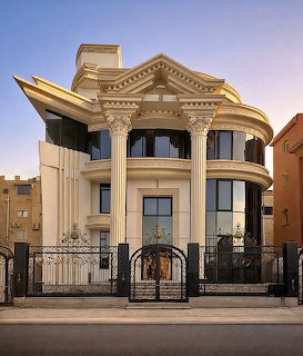 Grand luxury house facade with tall columns, curved balconies, and an iron gate