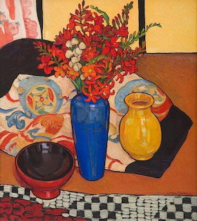 Vibrant still life painting with blue vase of red flowers, yellow jug, and bowl on patterned tablecloth