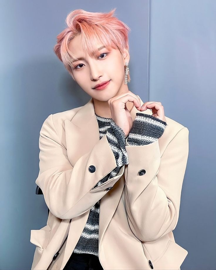 Young man with dark hair in a stylish portrait, K-pop idol Seonghwa of ATEEZ.