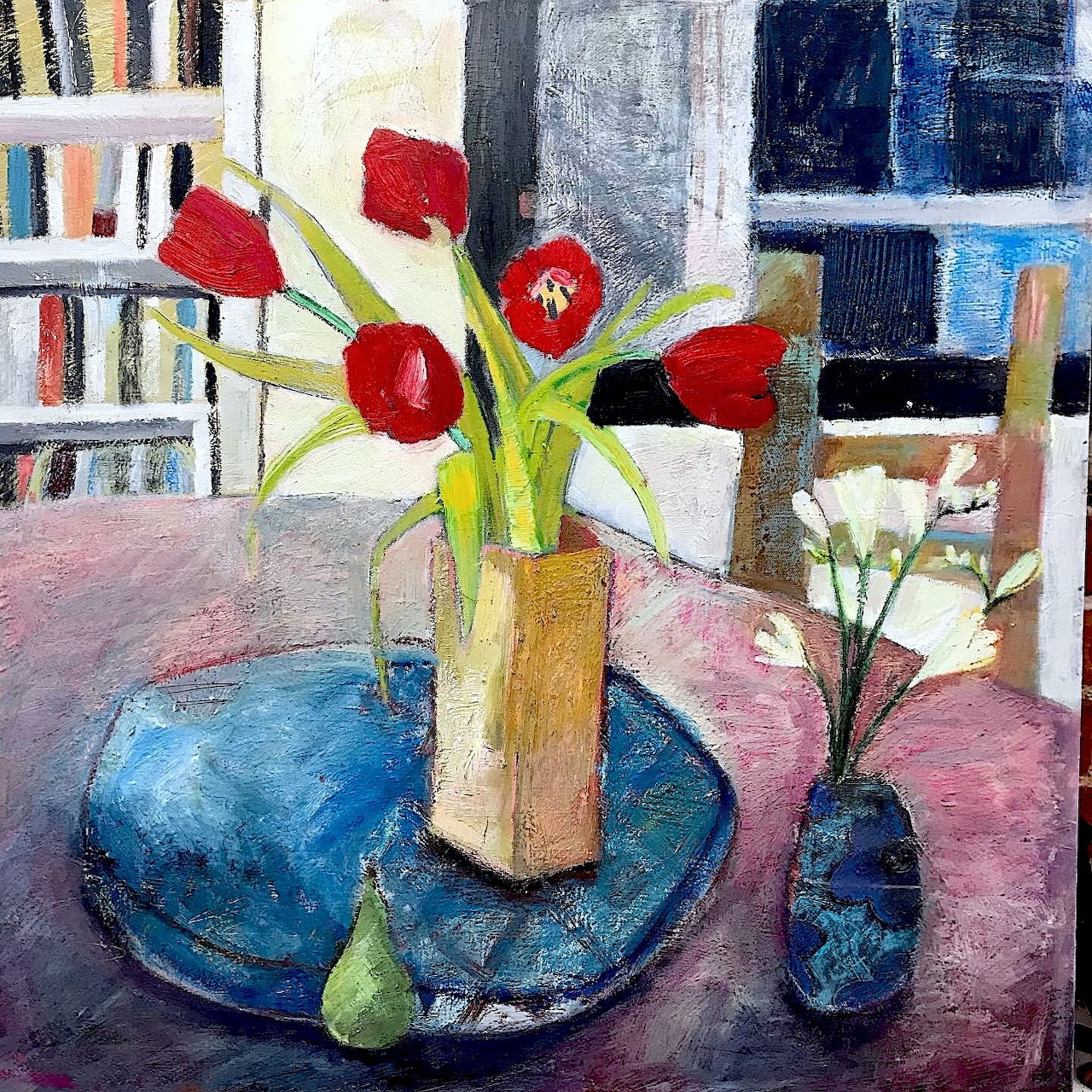Oil painting of red tulips in vase with blue plate and pear on table in colorful interior setting