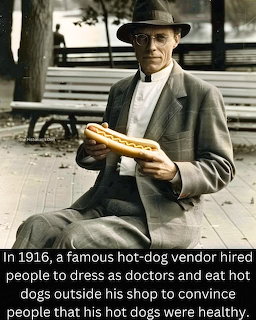 1916 photo of hot dog vendor in suit and hat holding oversized hot dog on city street