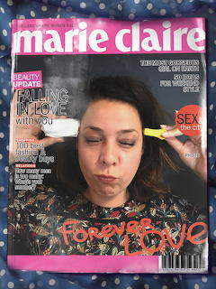 Marie Claire magazine cover with a woman applying makeup and bold beauty headlines