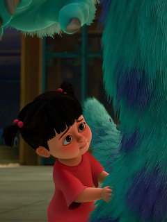 Animated character Boo hugging Sulley's fury blue leg in Monsters Inc scene