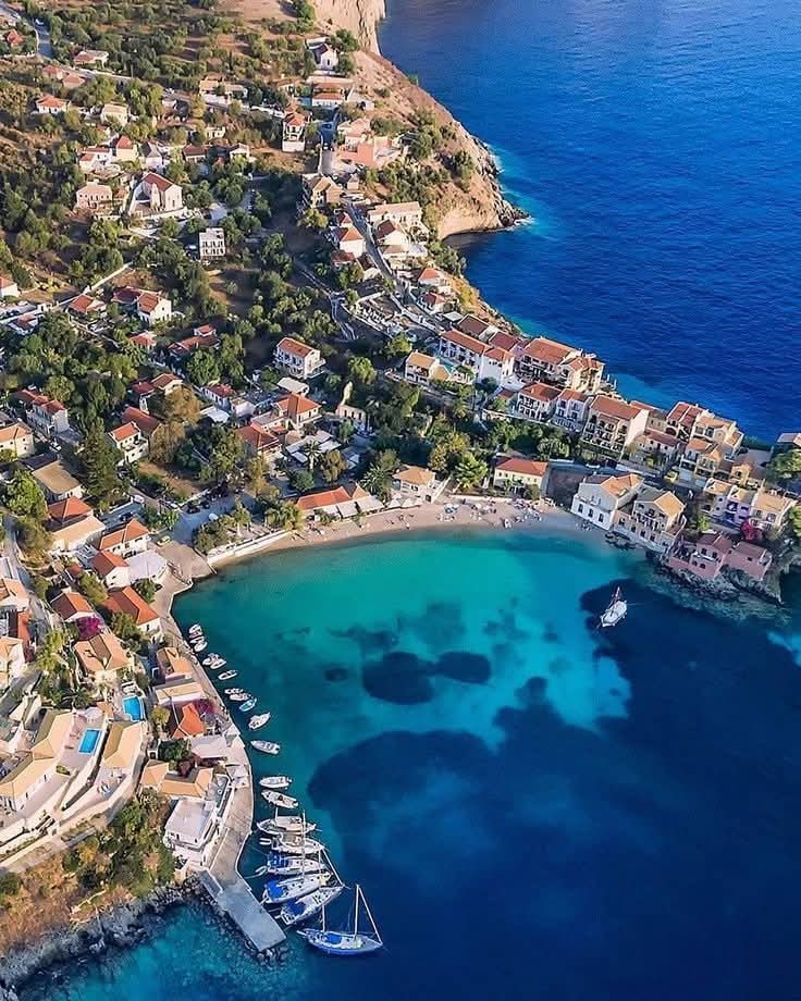 Aerial view of Assos village, Kefalonia, Greece, with turquoise bay and boats