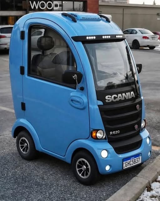 Small bright blue Scania mini truck parked outdoors with black accents and roof lights