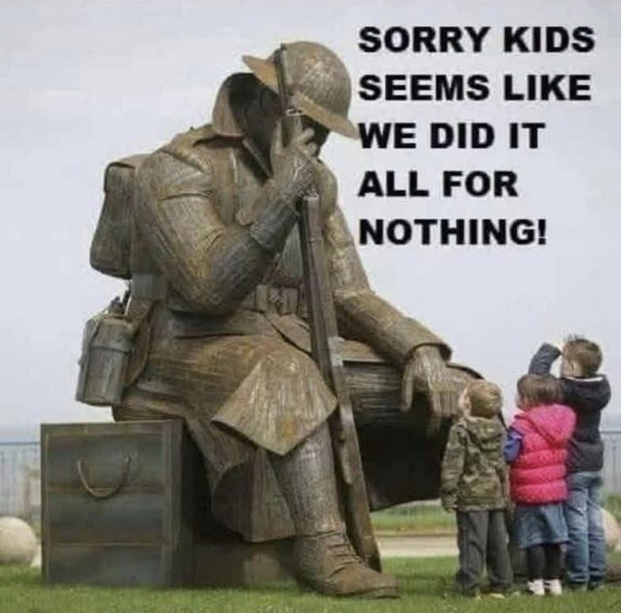Bronze statue of exhausted soldier sitting with gear, children viewing memorial