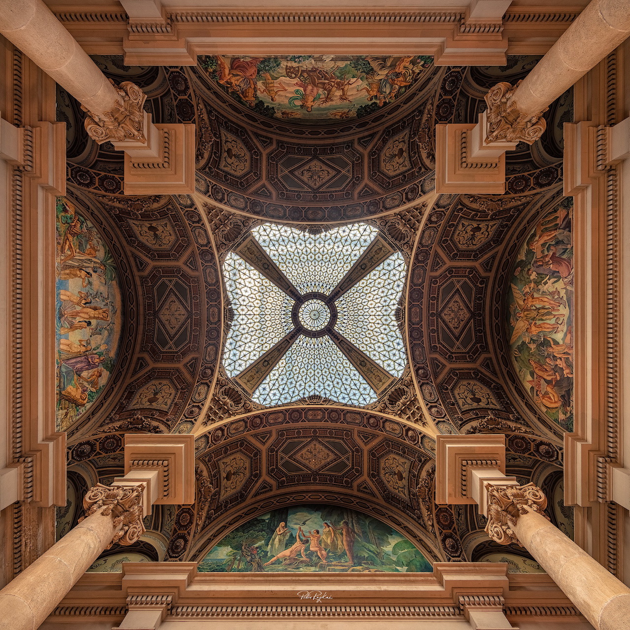 Ornate ceiling with columns, frescoes, arches, and a central skylight